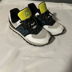New Balance Men’s Sneakers in Black, White, Blue, and Yellow.
